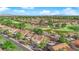 Overhead view of homes next to a golf course with a neighborhood featuring well-manicured landscaping and a mountain backdrop at 9013 Litchfield Ave, Las Vegas, NV 89134