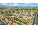 An aerial view of a golf course community with tree-lined streets, single Gathering homes, and lush green fairways at 9013 Litchfield Ave, Las Vegas, NV 89134