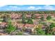 An overhead view of a golf course community with tree-lined streets, single Gathering homes and mountain views at 9013 Litchfield Ave, Las Vegas, NV 89134