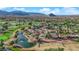 Aerial view of a golf course community featuring a lake, lush green fairways, and well-manicured landscaping at 9013 Litchfield Ave, Las Vegas, NV 89134