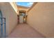 A covered entrance to a home with a tiled pathway and a decorative front door at 9013 Litchfield Ave, Las Vegas, NV 89134