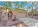 Welcoming home with a gated front entry, mature trees, and a convenient two-car garage at 9013 Litchfield Ave, Las Vegas, NV 89134