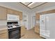 Cozy kitchen equipped with a stove, microwave, and a refrigerator near the laundry area at 9013 Litchfield Ave, Las Vegas, NV 89134