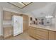 Bright kitchen featuring tile floors, spacious countertops, and modern appliances and cabinets at 9013 Litchfield Ave, Las Vegas, NV 89134