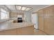 Kitchen featuring breakfast bar, tile flooring, and white appliances at 9013 Litchfield Ave, Las Vegas, NV 89134