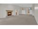 Large living area with a fireplace, high ceilings, and ample natural light from the front windows at 9013 Litchfield Ave, Las Vegas, NV 89134