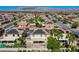Aerial view of neighborhood featuring community homes, solar panels, desert landscaping, and mountain views at 913 Evening Fawn Dr, North Las Vegas, NV 89031