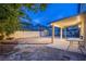 Covered patio in backyard features ample lighting and space for entertaining in the spacious outdoor area at 913 Evening Fawn Dr, North Las Vegas, NV 89031
