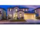 Charming two-story home boasts a well-manicured lawn, attached two car garage, and welcoming front entry at 913 Evening Fawn Dr, North Las Vegas, NV 89031