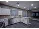 Eat-in kitchen with white cabinets, granite countertops, stainless steel appliances and tile backsplash at 913 Evening Fawn Dr, North Las Vegas, NV 89031