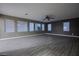 Spacious living room features multiple windows for natural light and modern wood-look floors, enhancing its appeal at 913 Evening Fawn Dr, North Las Vegas, NV 89031