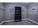 Convenient walk-in closet features multiple shelves, built in security safe, and neutral carpeting at 913 Evening Fawn Dr, North Las Vegas, NV 89031
