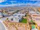 Panoramic aerial view of the home nestled in a vibrant community with stunning mountain backdrop at 940 Riverlawn Pl, Las Vegas, NV 89138