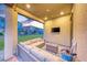 Covered back porch with comfortable outdoor seating, a ceiling fan, and a view of the backyard at 940 Riverlawn Pl, Las Vegas, NV 89138