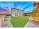 Wide shot of backyard with green lawn and privacy wall at 940 Riverlawn Pl, Las Vegas, NV 89138