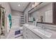Well-lit bathroom featuring a double vanity and a shower-tub combo at 940 Riverlawn Pl, Las Vegas, NV 89138