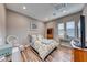 Well-lit bedroom featuring a full bed, wood floors, and ample lighting at 940 Riverlawn Pl, Las Vegas, NV 89138