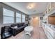Cozy bonus room with large sofa, bright windows, custom shelving and convenient access to the rest of the home at 940 Riverlawn Pl, Las Vegas, NV 89138