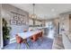 Dining room with modern furnishings and an open view to the kitchen at 940 Riverlawn Pl, Las Vegas, NV 89138