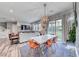 Bright dining area featuring modern decor with an open layout to the living room and backyard at 940 Riverlawn Pl, Las Vegas, NV 89138