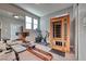 Modern exercise room featuring a sauna, mirrors, and fitness equipment, creating a dedicated workout space at home at 940 Riverlawn Pl, Las Vegas, NV 89138