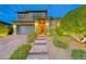 Charming two-story home with a two-car garage and brick steps leading to the entrance at 940 Riverlawn Pl, Las Vegas, NV 89138