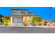 Charming two-story home featuring a two-car garage and professionally landscaped front yard at 940 Riverlawn Pl, Las Vegas, NV 89138
