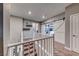 Spacious hallway with white barn door, neutral paint, and plush carpet leading to secondary bedrooms and bathrooms at 940 Riverlawn Pl, Las Vegas, NV 89138