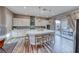 Modern kitchen with stainless steel appliances, a spacious island, and a view to the outdoor patio at 940 Riverlawn Pl, Las Vegas, NV 89138