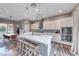 Open kitchen layout with a large island, bar stool seating, and modern lighting at 940 Riverlawn Pl, Las Vegas, NV 89138