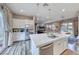 Modern kitchen with a large island, stainless steel appliances, and an open layout to the living spaces at 940 Riverlawn Pl, Las Vegas, NV 89138