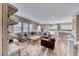 Open living room design featuring a large sofa, hardwood floors, and stylish decor at 940 Riverlawn Pl, Las Vegas, NV 89138