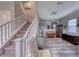 Inviting living room showcasing a piano, display cabinet, and stylish decor beneath the staircase leading to the second floor at 940 Riverlawn Pl, Las Vegas, NV 89138