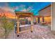 Relaxing outdoor space featuring a grill and comfortable seating with a pergola at 940 Riverlawn Pl, Las Vegas, NV 89138