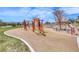 Colorful community playground with various climbing structures, slides, and safe play surfaces at 940 Riverlawn Pl, Las Vegas, NV 89138