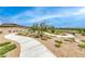 Scenic community walking path winding through desert landscape with views of nearby homes at 940 Riverlawn Pl, Las Vegas, NV 89138