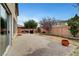 Backyard features a concrete patio with BBQs and a brick perimeter wall at 10247 Gladstone Peak St, Las Vegas, NV 89166