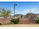 Fenced backyard featuring beautiful mountain views, lush greenery, and mature landscaping at 10247 Gladstone Peak St, Las Vegas, NV 89166