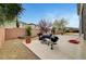 Wide-open backyard featuring a concrete patio and BBQs at 10247 Gladstone Peak St, Las Vegas, NV 89166