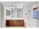 Bright bathroom featuring double sinks, a large mirror, and a tub with modern fixtures at 10247 Gladstone Peak St, Las Vegas, NV 89166