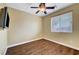 Empty bedroom with hardwood flooring and ceiling fan, offering a neutral space for customization at 10247 Gladstone Peak St, Las Vegas, NV 89166
