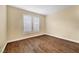 Bedroom featuring wood floors, window shutters, and neutral paint at 10247 Gladstone Peak St, Las Vegas, NV 89166