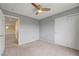 Bedroom with carpeted flooring, ceiling fan, and a sliding door closet at 10247 Gladstone Peak St, Las Vegas, NV 89166