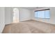 Bedroom with neutral walls and carpets, plus an attached bathroom featuring modern fixtures at 10247 Gladstone Peak St, Las Vegas, NV 89166