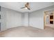 Bedroom with a ceiling fan, carpeted flooring, and a sliding door closet at 10247 Gladstone Peak St, Las Vegas, NV 89166