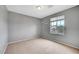 Neutral bedroom featuring a large window and carpeted flooring at 10247 Gladstone Peak St, Las Vegas, NV 89166