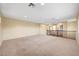 Spacious bonus room featuring neutral carpet, soft yellow walls, and a classic wooden railing at 10247 Gladstone Peak St, Las Vegas, NV 89166