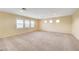 A large bonus room with carpeted flooring and plantation shutters on the windows, ready for your imagination at 10247 Gladstone Peak St, Las Vegas, NV 89166
