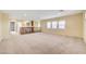 Expansive bonus room with neutral carpet, bright natural light, and a traditional wooden railing at 10247 Gladstone Peak St, Las Vegas, NV 89166