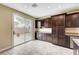 An eat-in kitchen area features dark wood cabinets, granite countertops, and a sliding glass door leading to the backyard at 10247 Gladstone Peak St, Las Vegas, NV 89166